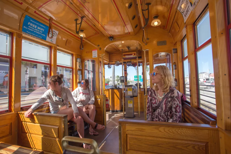 Passengers inside wood-paneled TECO streetcar in Tampa, Florida